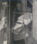 DISAPPEARING into the hold of the S. S. African Pilgrim at New York for shipment to Mombasa, British East Africa, is one of the eight International trucks selected by Gatti for the arduous work of transporting his expedition