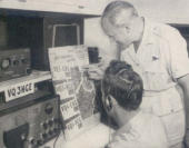  CMDR. GATTI and one of his radio operators check the expedition's itinerary as work on the Masai and Sonyo tribes was being finished. 